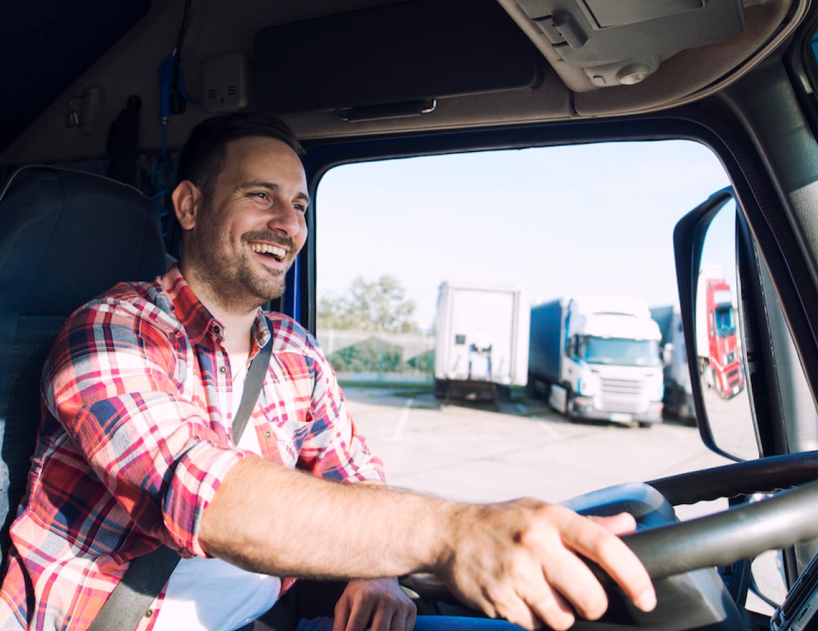 Uśmiechnięty kierowca samochodu transportuje ryby do klienta Hodowli Pstrąga Koniecpol.